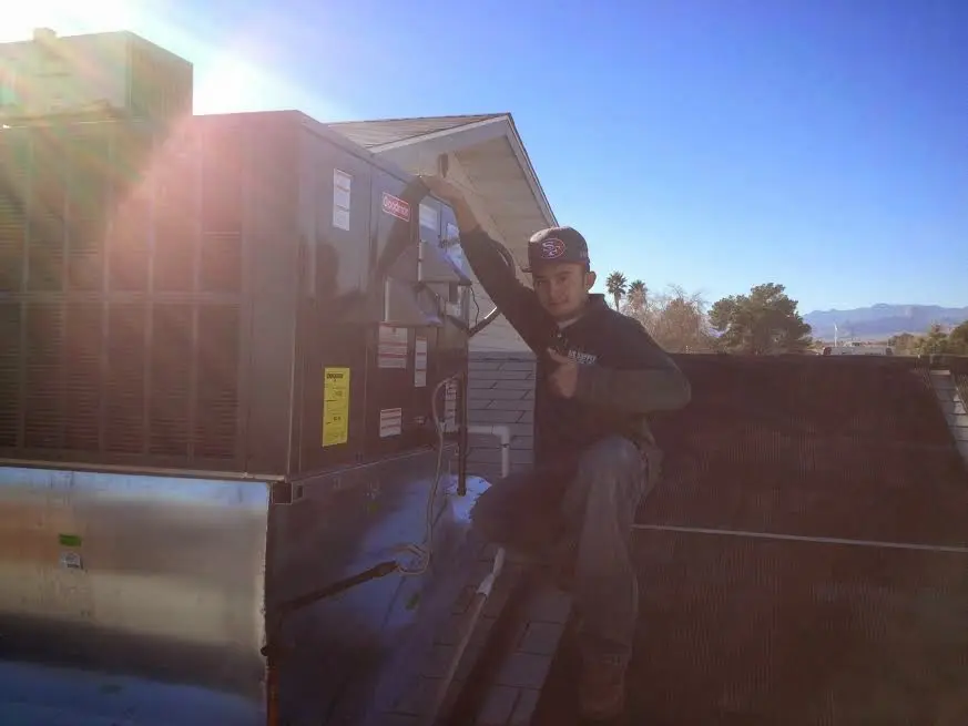 HVAC technician performing HVAC Inspection on a rooftop unit in Claverack